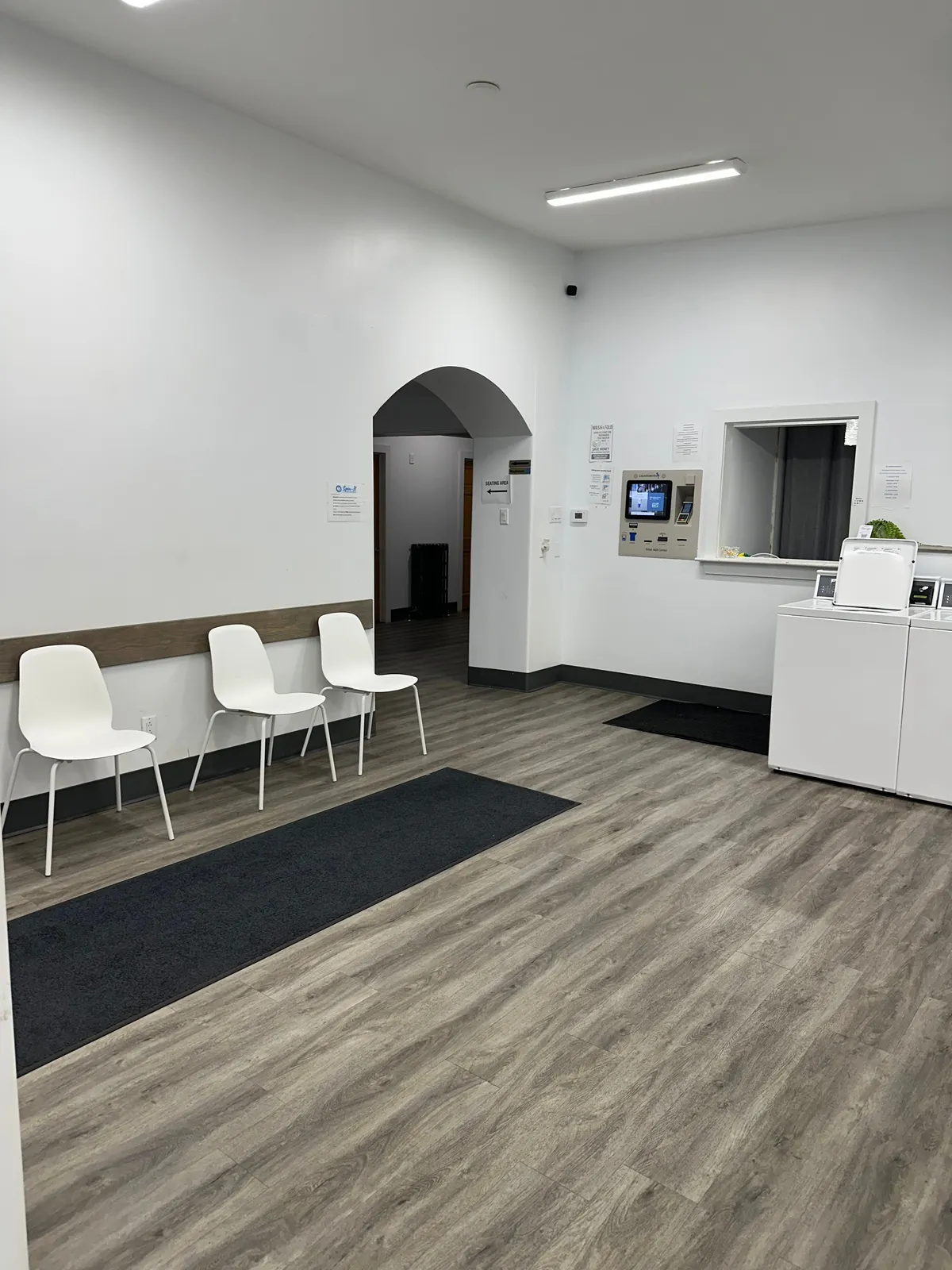 Walk-in seating near the front desk and Value Add Center at Spin-It Laundromat